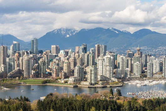 Vancouver British Columbia skyline with harbor and mountains